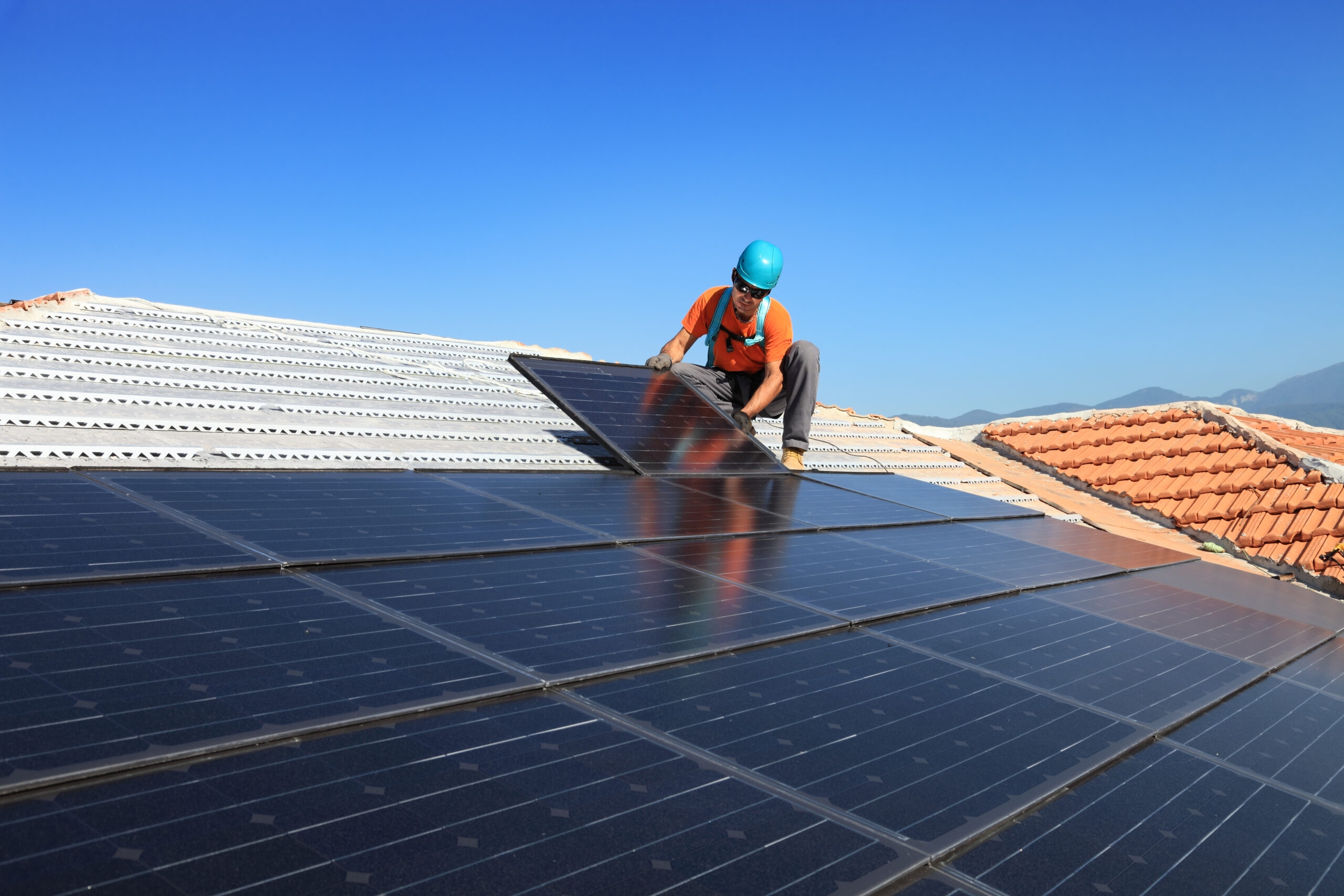 Contractor Installing Solar Panels on roof